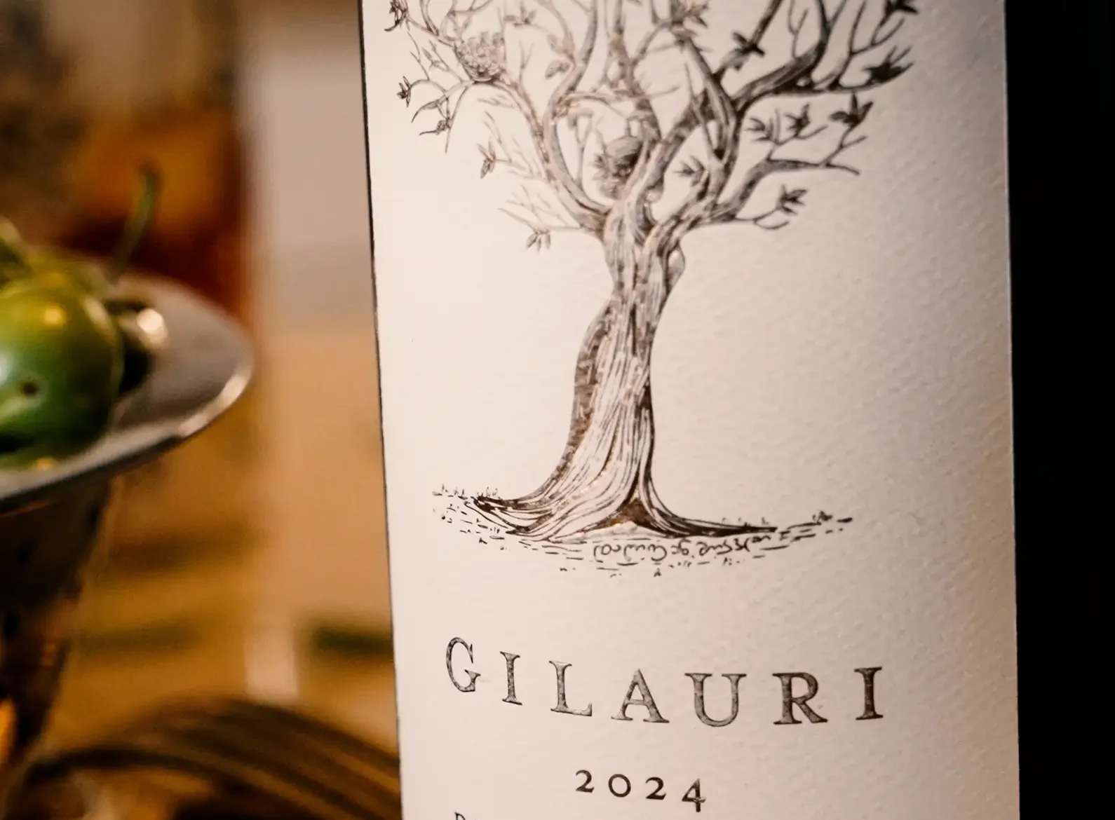 A wine bottle label with a drawing of a tree, "GILAURI" in large letters, "2024" below, and "DURUJI VINEYARD" at the bottom.